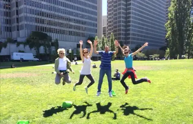 Team jumps in the air simultaneously on a grassy area in San Francisco