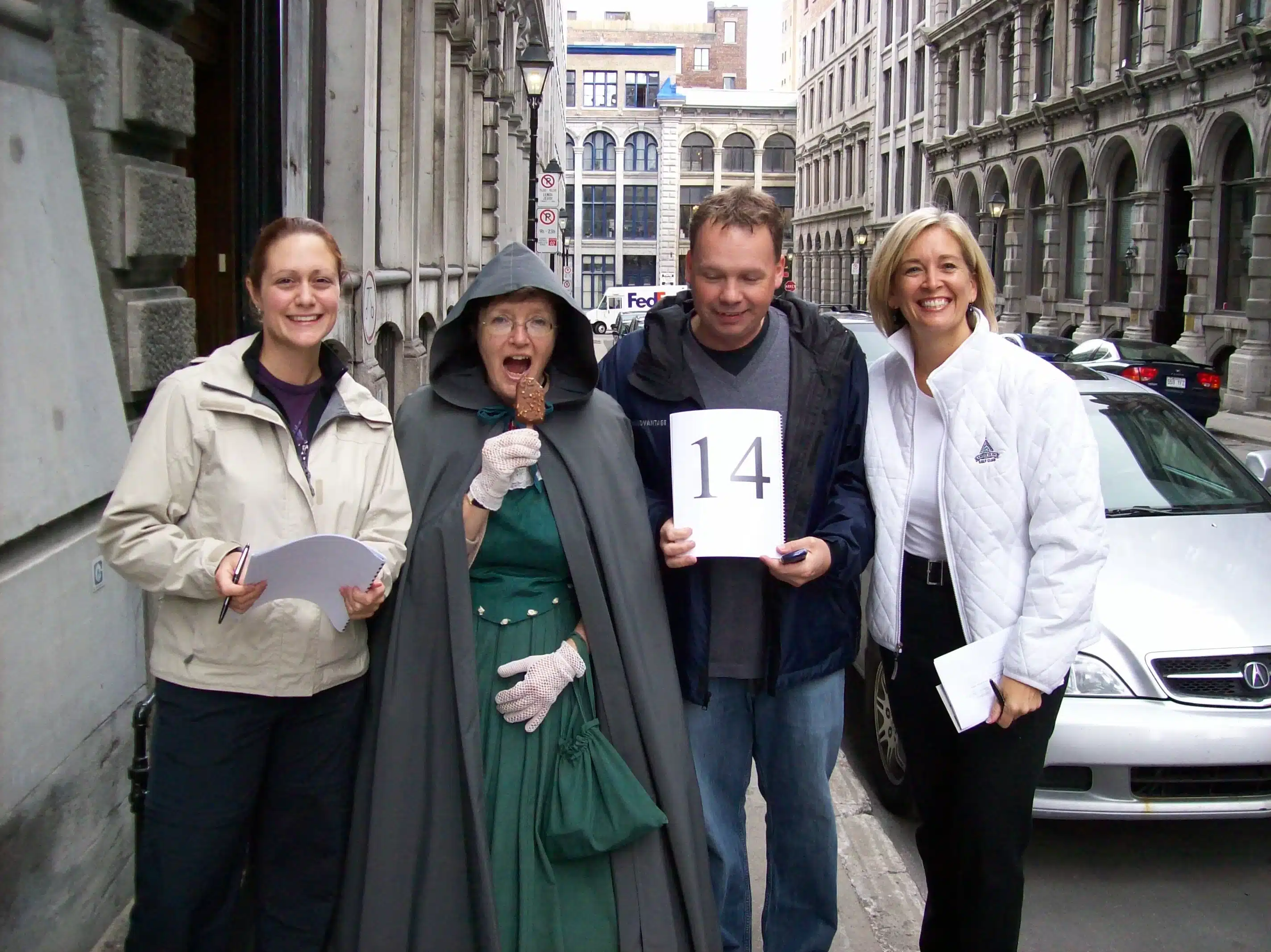 Scavenger hunt team poses with someone dressed as a habitant.