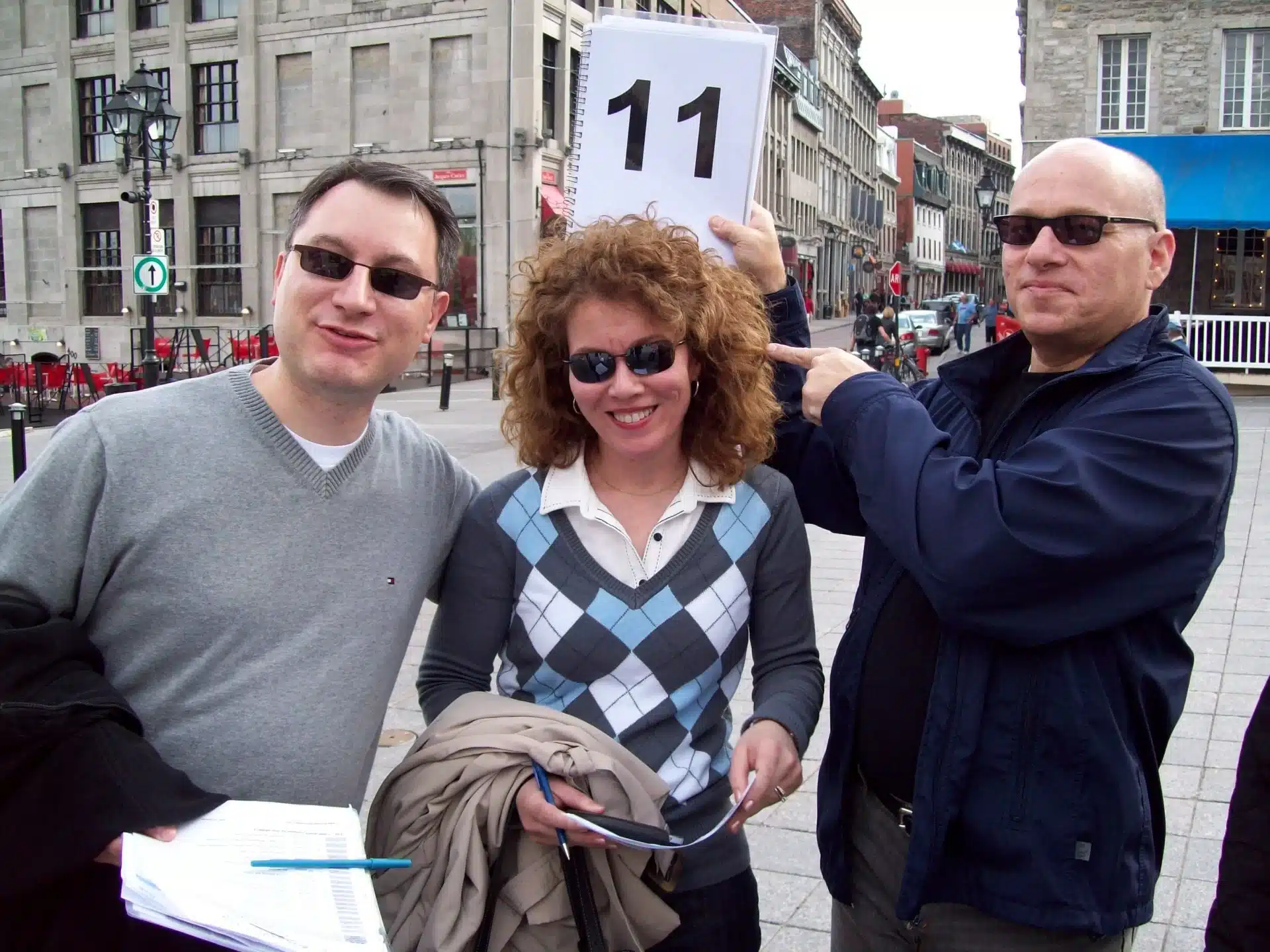 Three people, one with a large number 11 above her head.
