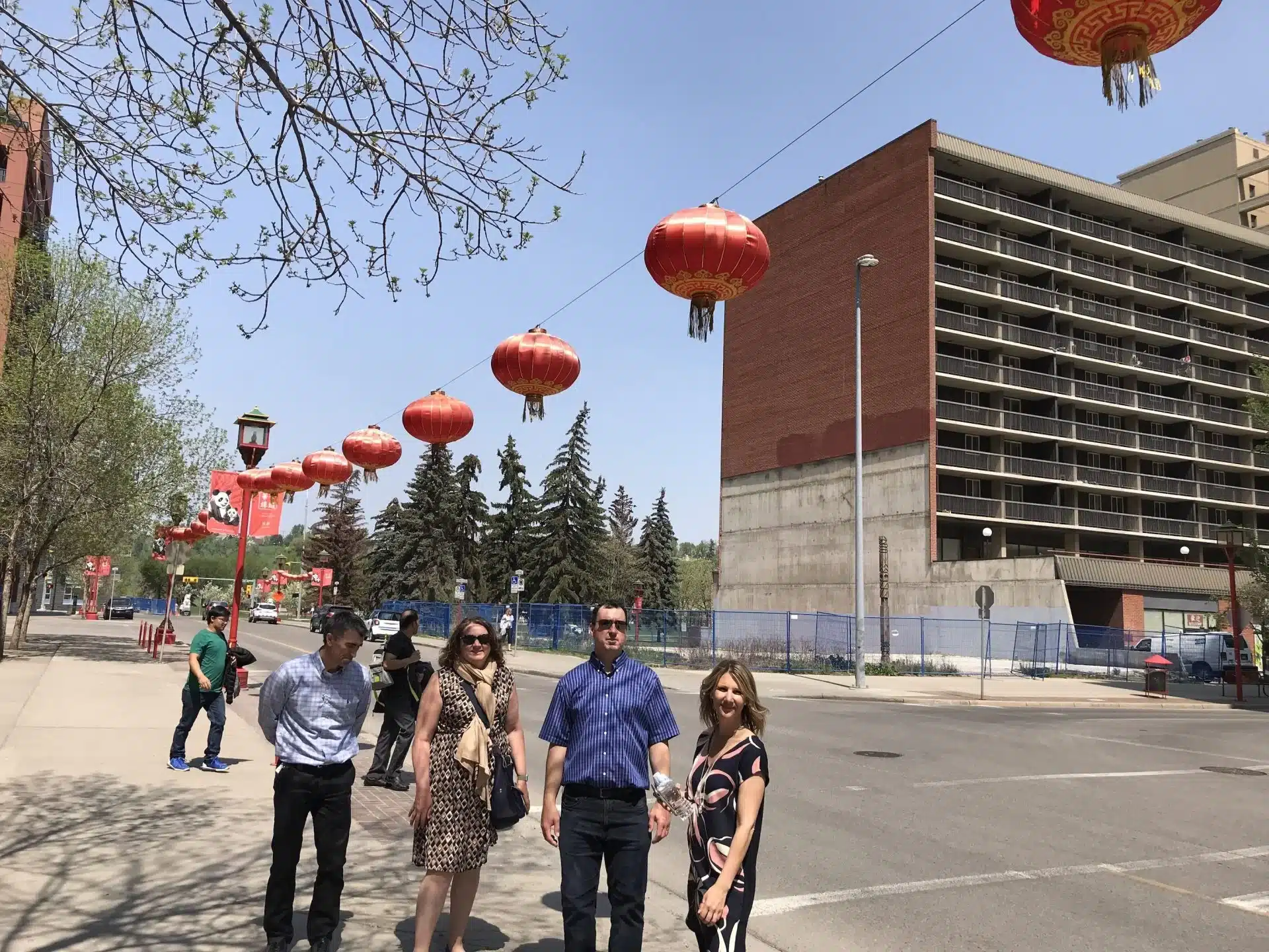 Corporate scavenger hunt team under the red lanterns in Chinatown of Calgary