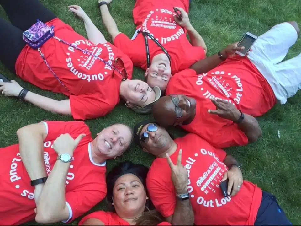 Team rests on the grass and takes a selfie during New York Midtown Scavenger Hunt