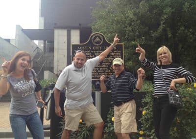 Scavenger Hunt team dancing at the Austin City Limits historical plaque.