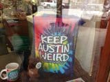 Keep Austin Weird merchandise in a store window.