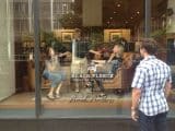 Scavenger hunters pose like dummies in a store window.