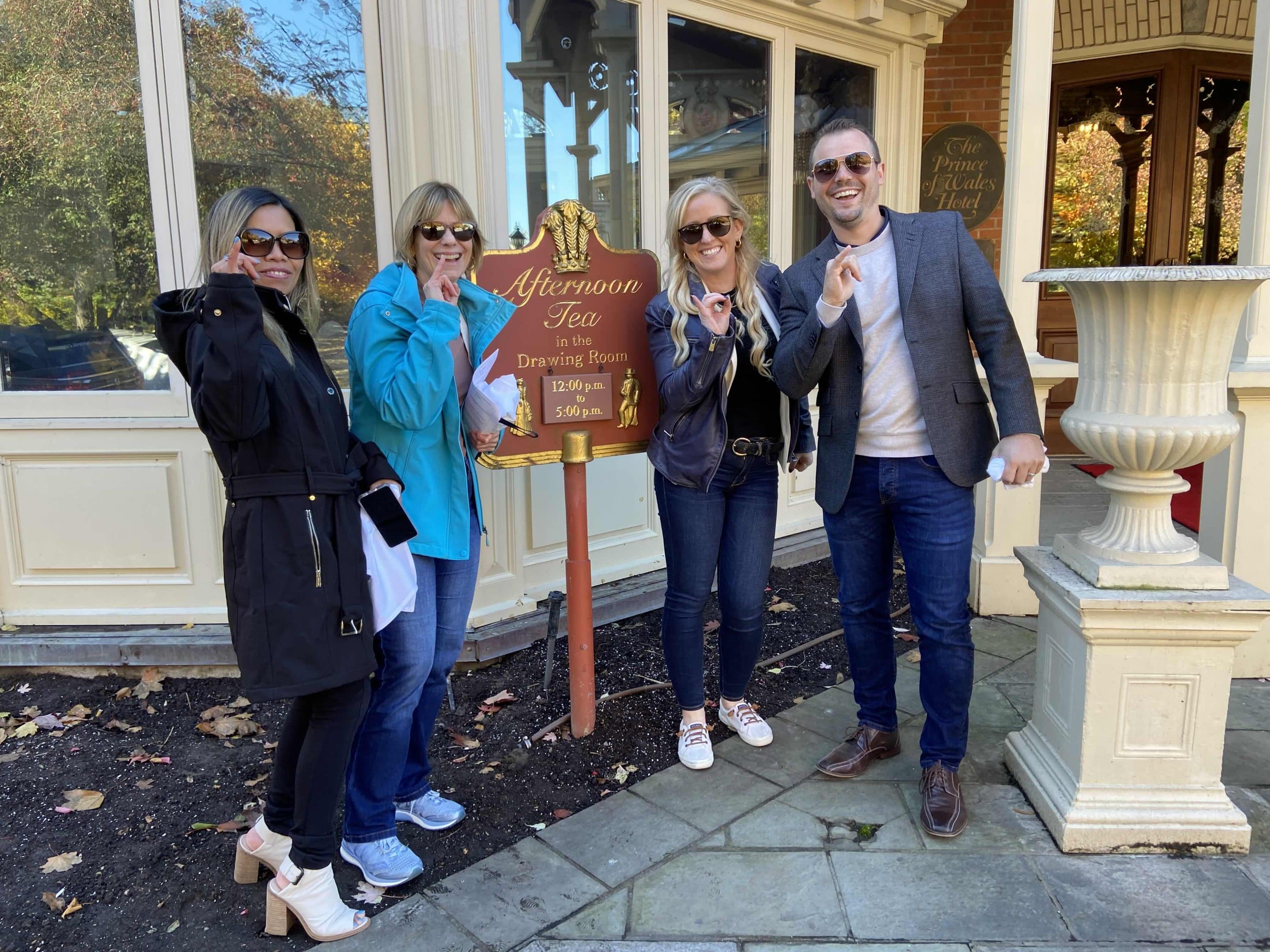 4 people at the afternoon tea sign