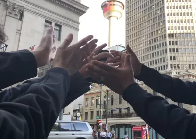Team reaching for Calgary Tower in scavenger hunt photo
