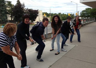6 team members getting ready to bat during a team building activity in Guelph.