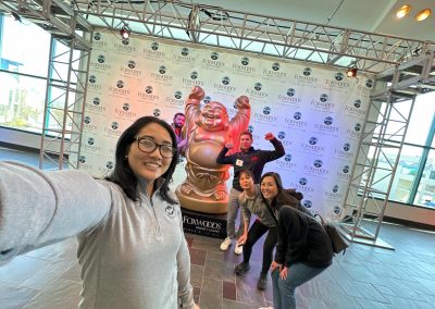 5 team members taking a selfie with a giant sculpture during a team building activity in Foxwoods.