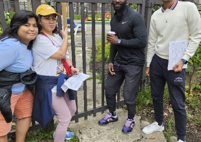 Scavenger hunt team members standing in front of a massive gate