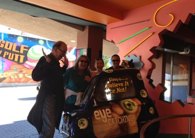 4 team members sit on a Ripley's cart during a team building activity in Niagara Fall.