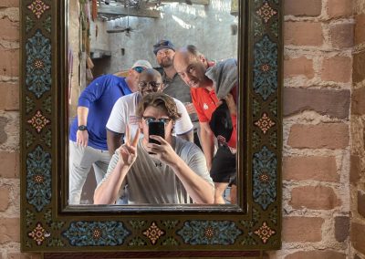 A team of 5 taking a mirror selfie during a team building activity in Orlando.