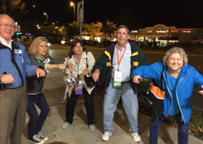Team of 5 members acting like they are riding a bike