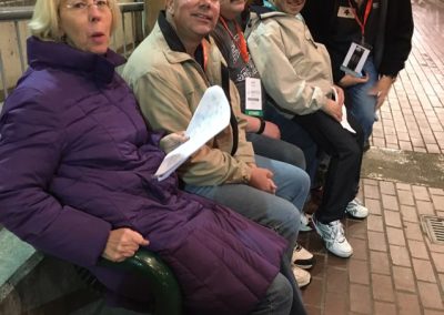 Team sitting on a bench looking at the camera