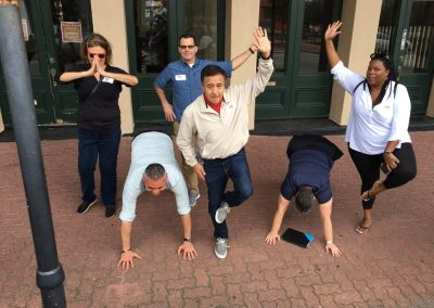 A scavenger hunt team of six members doing some stretching in Galveston