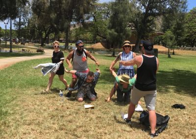 Two teams with three member each trying to make a human bicycle and being competitive