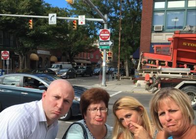 A scavenger hunt team of four members looking at the camera and making a sad face