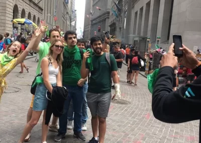 Five people taking a photo in the streets of New York surrounded by buildings