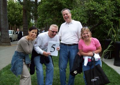 Four scavenger hunt team members doubled over, laughing uncontrollably.