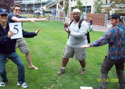 A scavenger hunt team of four men striking kung fu stances.