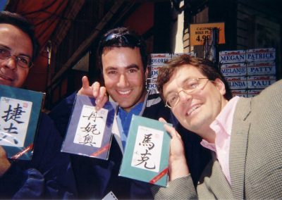 A scavenger hunt team of 3 taking a selfie, each holding a book