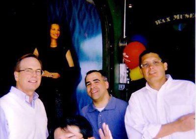 Four individuals are posing for a photo with a sculpture of Julia Roberts displayed in the background during the San Francisco Scavenger Hunt.
