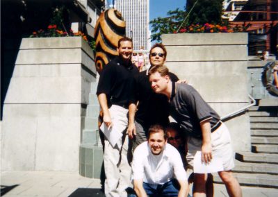Five men are posing for a photo, with three standing and two seated during the Seattle Downtown Scavenger Hunt.