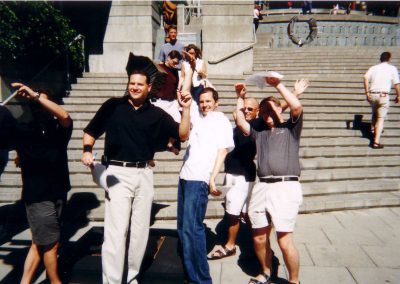 A group of five individuals taking a picture with their hands up during a team building activity in Seattle.