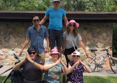 A team of six forms a pyramid structure: three at the base, two in the middle, and one at the top.