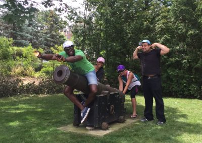 4 team members playing with a cannon during a team building activity in Toronto Old Mill.