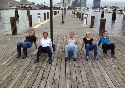 Teams doing a yoga pose during the Baltimore Scavenger Hunt.