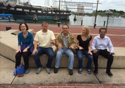 Scavenger hunt team members sitting on steps.