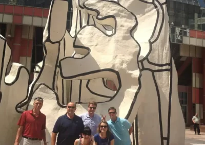Scavenger hunt team members stand in front of a giant structure.