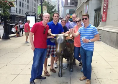 A scavenger hunt team posting with a bull.
