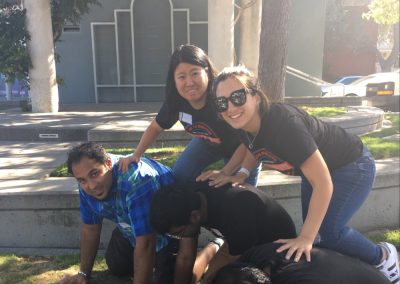 A scavenger hunt team of 5 makes a pyramid, 3 at the bottom,2 on the top