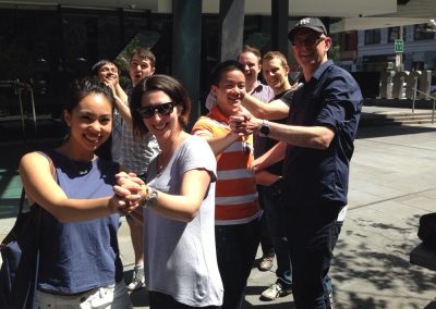 Scavenger hunt team members dancing in pairs.