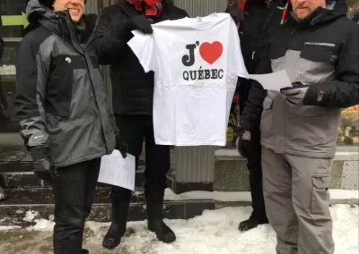 4 scavenger hunt team members holding up a I heart Quebec Tshirt.