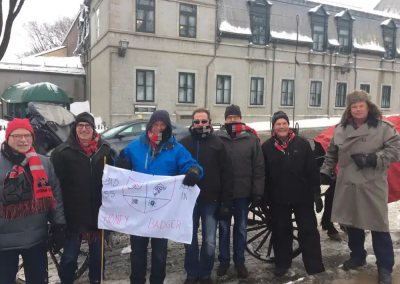 Team of 5 holding a cloth like a flag during a team building activity in Quebec.