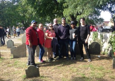 Scavenger hunt team takes a photo in a cemetery in Salem
