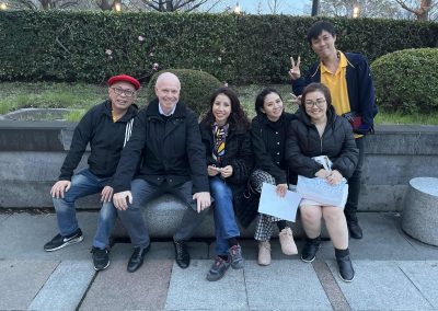 A team of 6 sitting on a bench during a team building activity in Ginza, Tokyo.