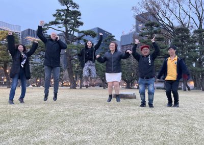 Team of 6 jumping during a team building activity in Ginza, Tokyo.