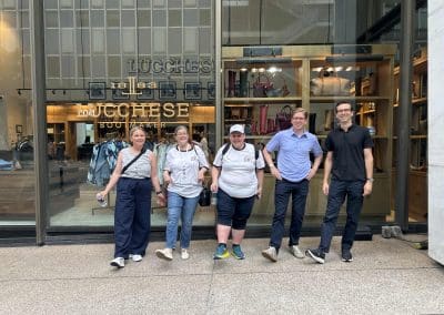 Team members stand together during a team building activity in Dallas