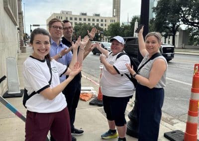 Scavenger hunt team pointing to a giant landmark