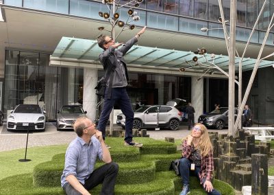 Team members stand doing fun poses during a team building activity in Vancouver