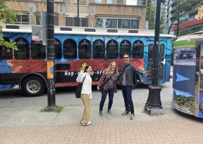 Scavenger hunt team members stand in front of a tram