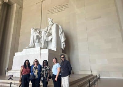 Team members take photo in front of Abrahma Lincon's statue in Washington DC