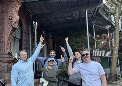 A scavenger hunt team points at a sign