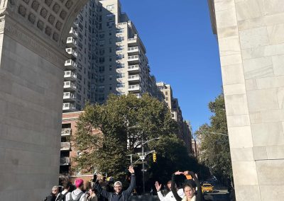Scavenger hunt team members stand under the Washington Square Arch